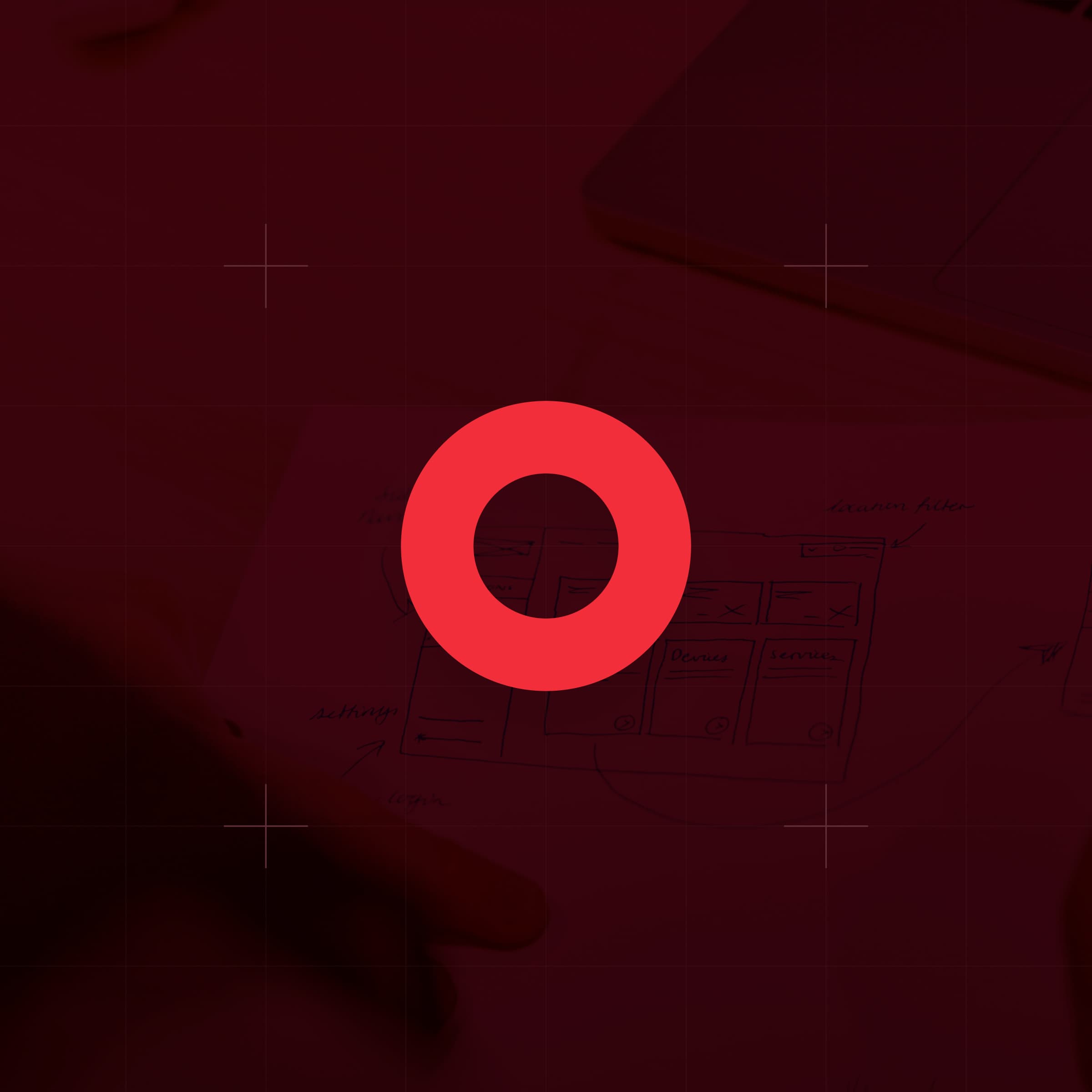 CodeFish Studio ring glyph over a red-tinted photo of hand-drawn interface sketches