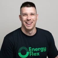 A smiling team member in an EnergyFlex branded T-shirt