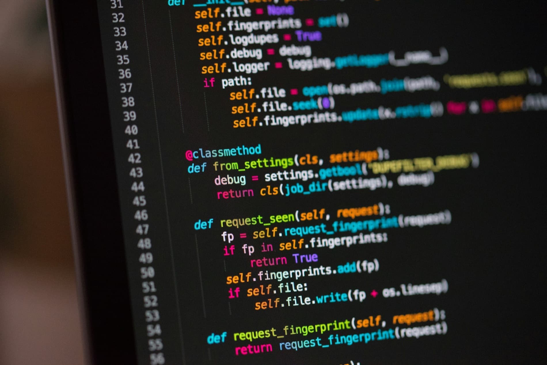 Close-up of a monitor showing syntax-highlighted Python code for a request fingerprint class